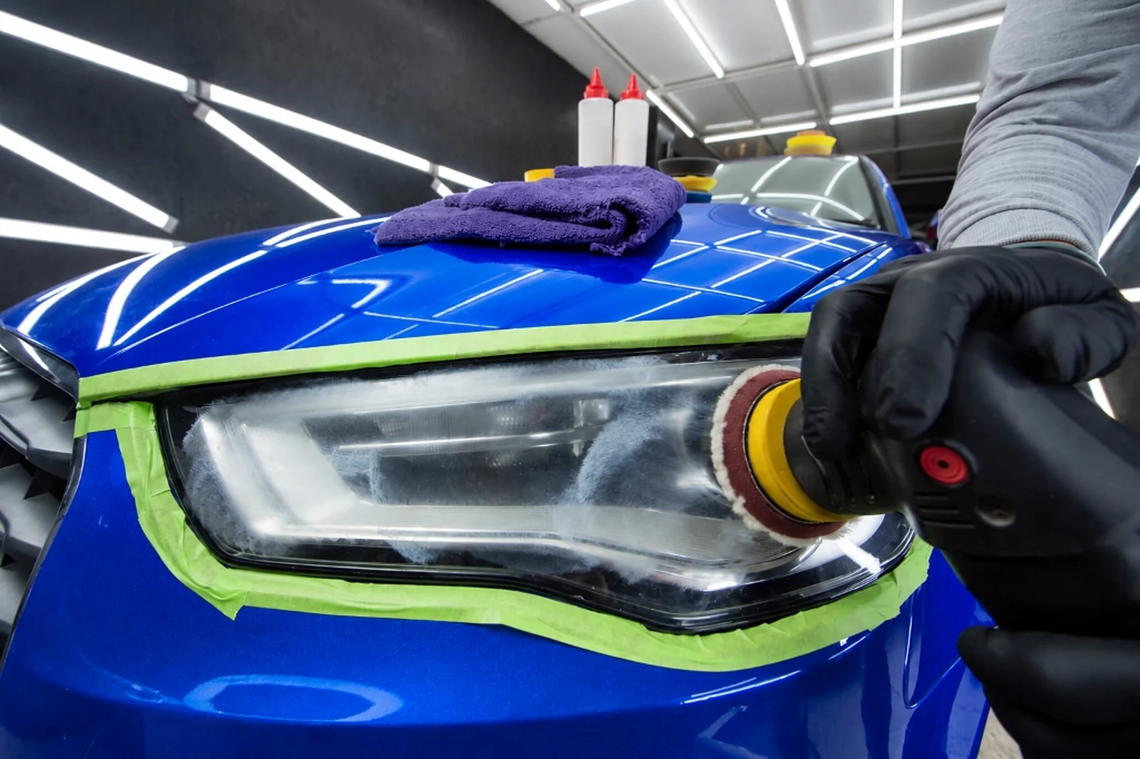 CleanWorx technician machine polishing oxidized headlight lens in the Basking Ridge, NJ shop