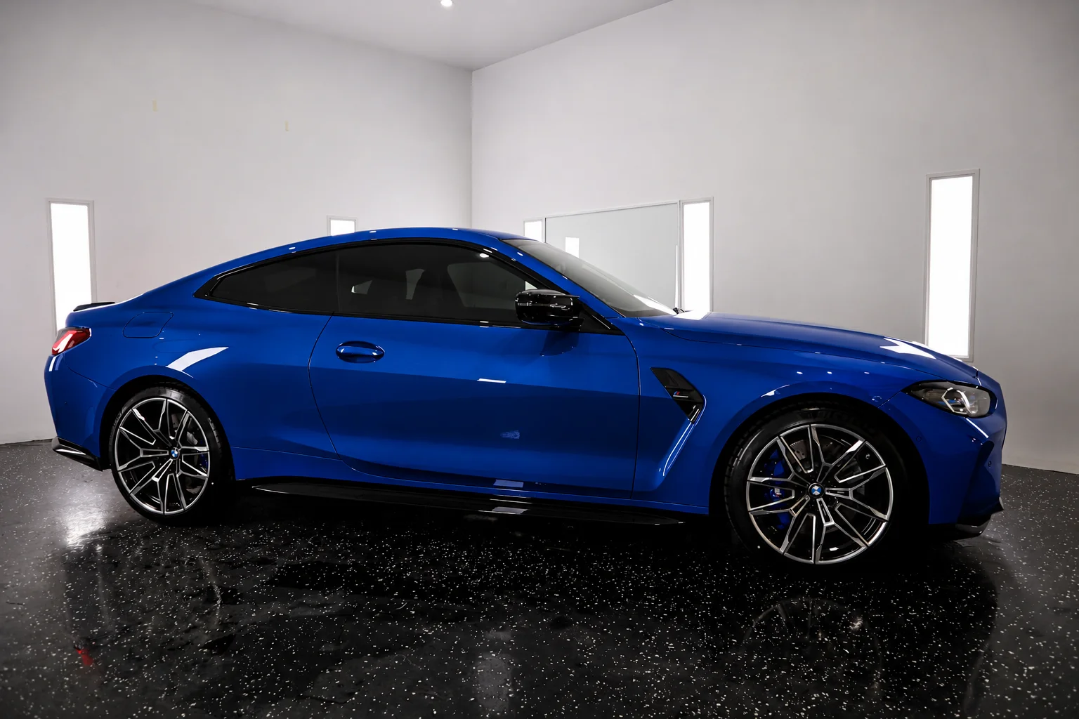 Precision automotive window tint installation on luxury BMW M4 coupe at the CleanWorx shop in Basking Ridge NJ