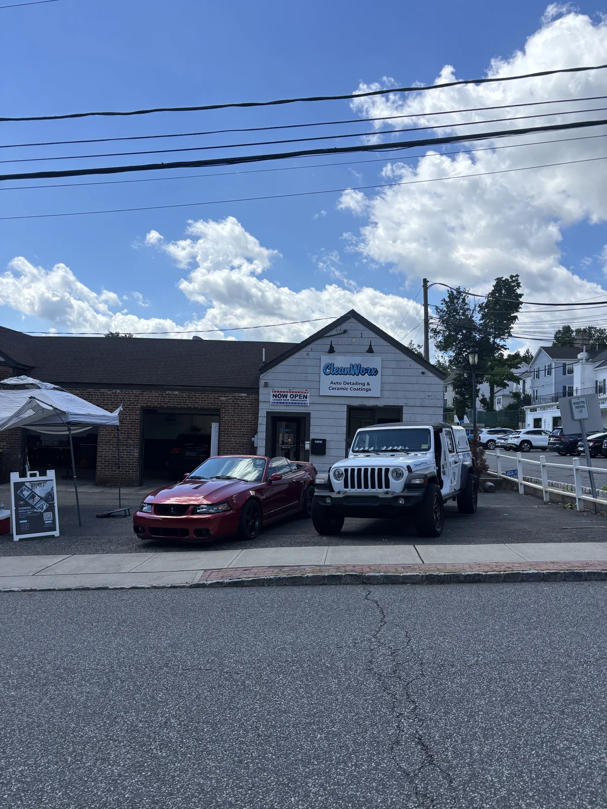 CleanWorx shop storefront in Basking Ridge NJ with mobile detailing unit and customer cars