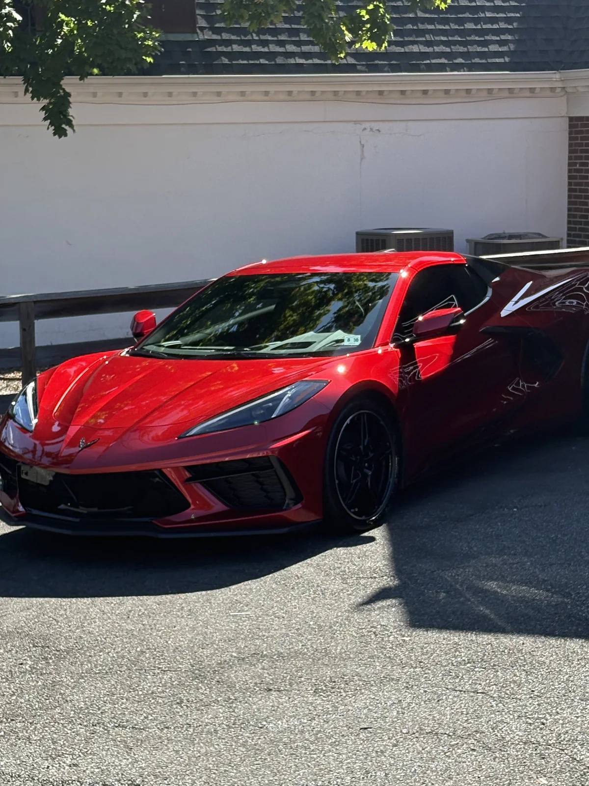 Chevrolet Corvette C8 in Torch Red with high gloss ceramic coating reflection in sunlight