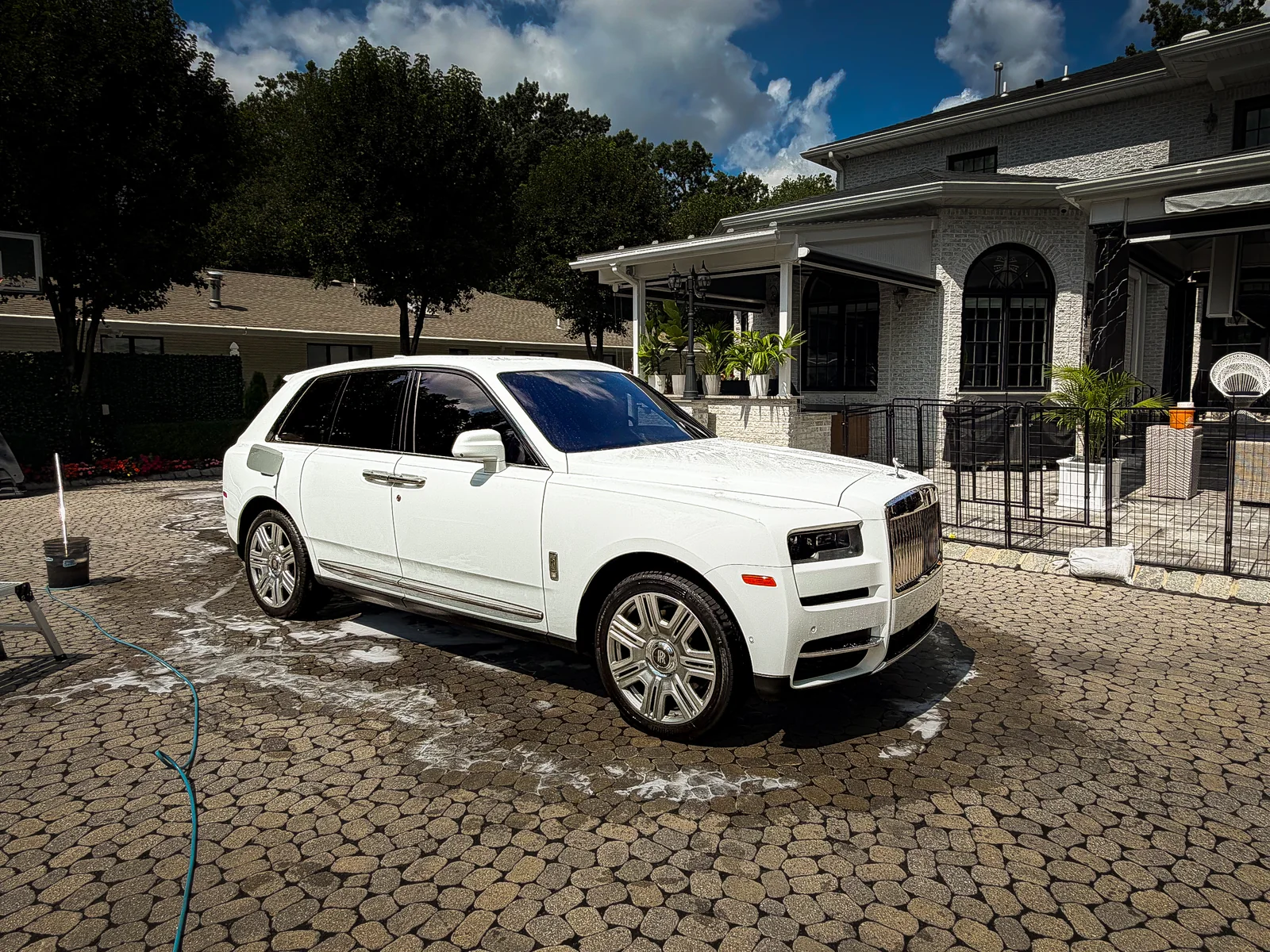 Rolls-Royce Cullinan luxury mobile detailing foam wash on cobblestone driveway in Somerset County NJ